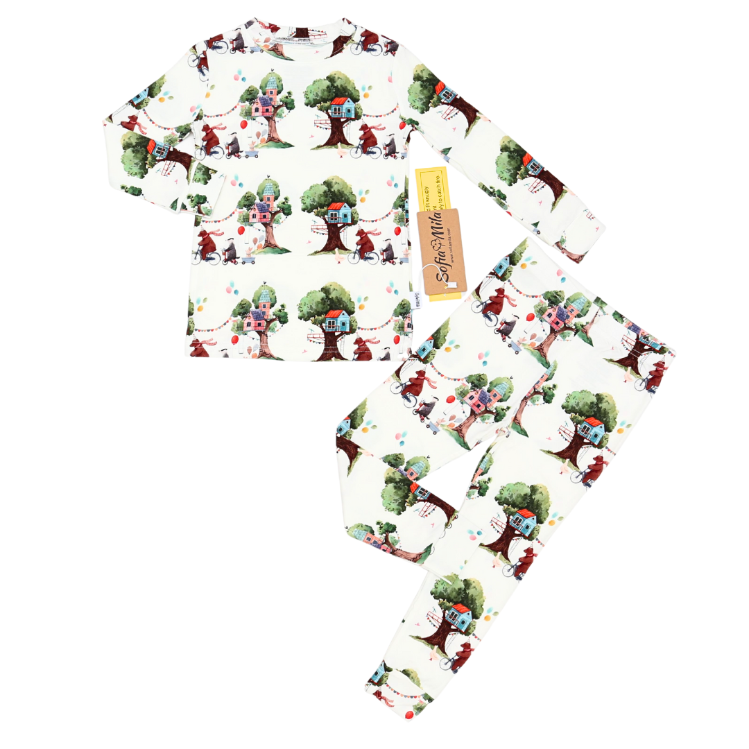 Set of pajama pants with a colorful tree and character design on a white background
