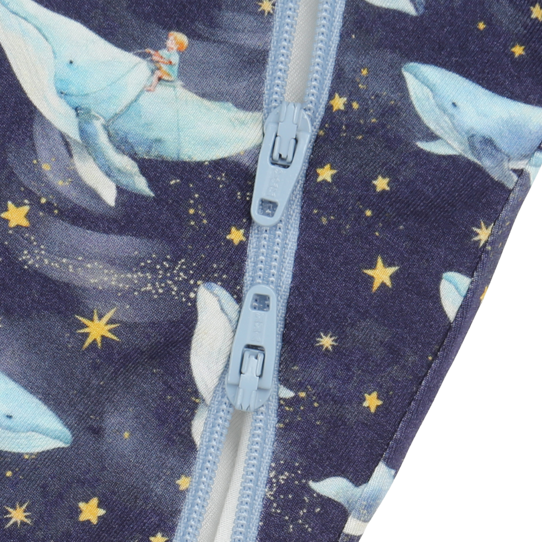 Close-up of a zipper on fabric with whale and star pattern