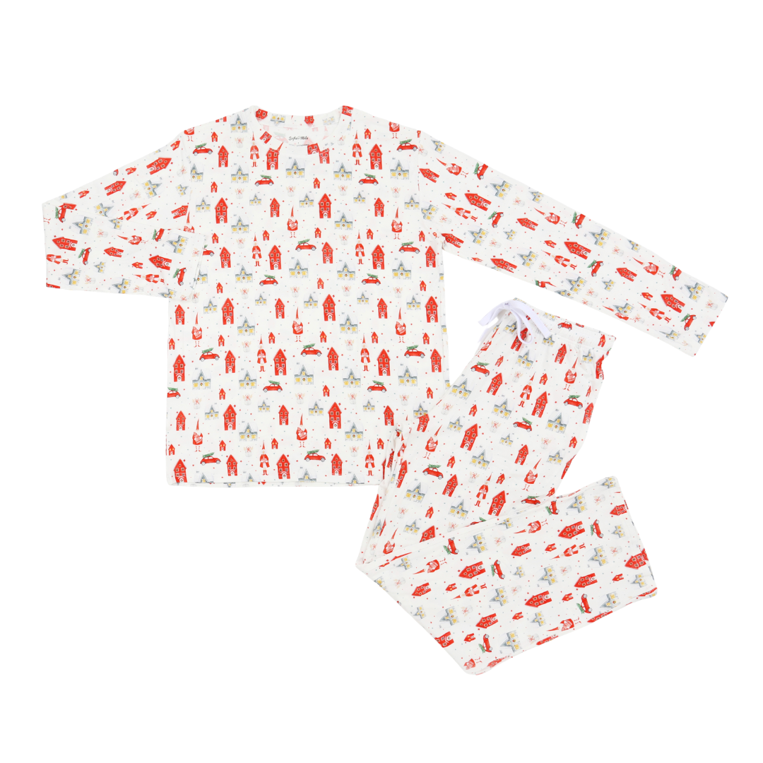 A two-piece pajama set with a long-sleeve top and matching pants, featuring an all-over festive print of red Santa Claus figures, green trees, and small red accents on a white background.