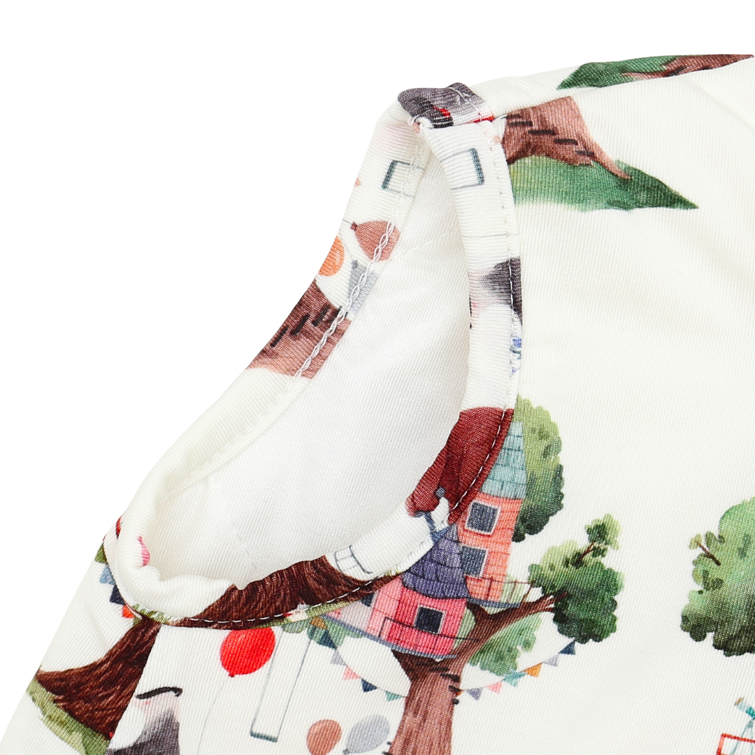 Fabric with a colorful house and tree pattern on a white background