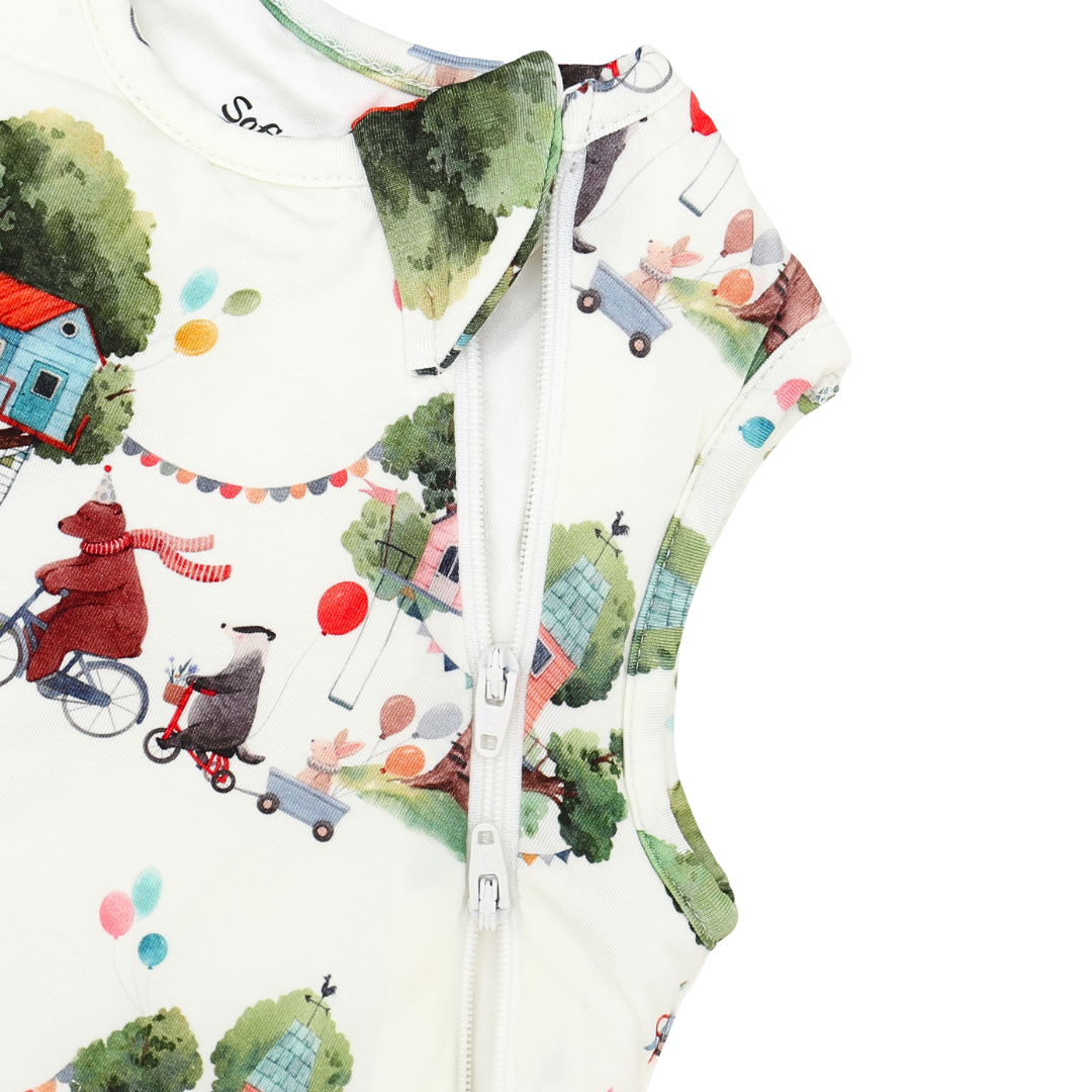 Children's jacket with a colorful pattern of houses, trees, and animals on a white background