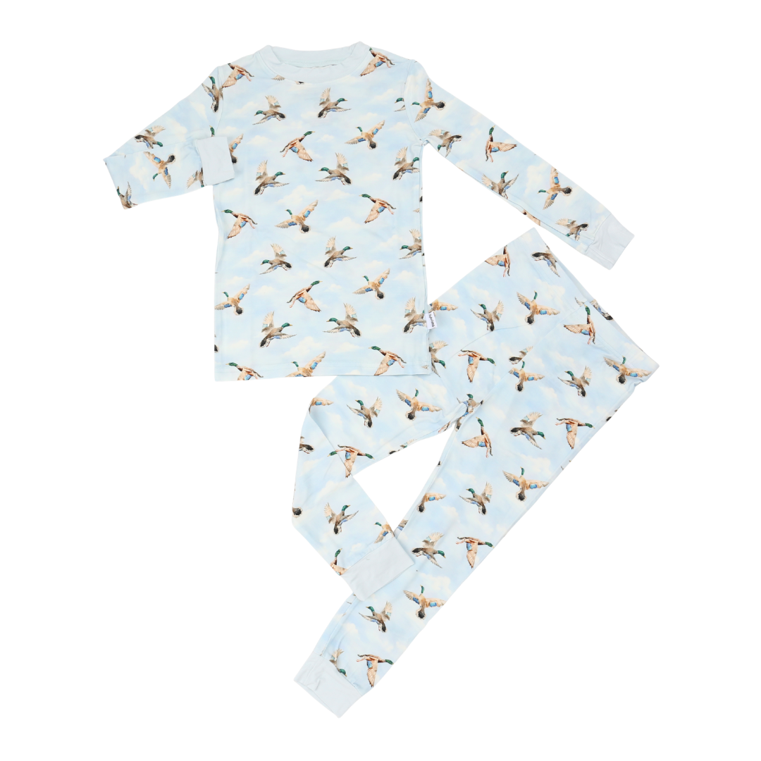 Children's pajama set with duck pattern on a light blue background