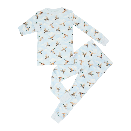 Children's pajama set with duck pattern on a light blue background