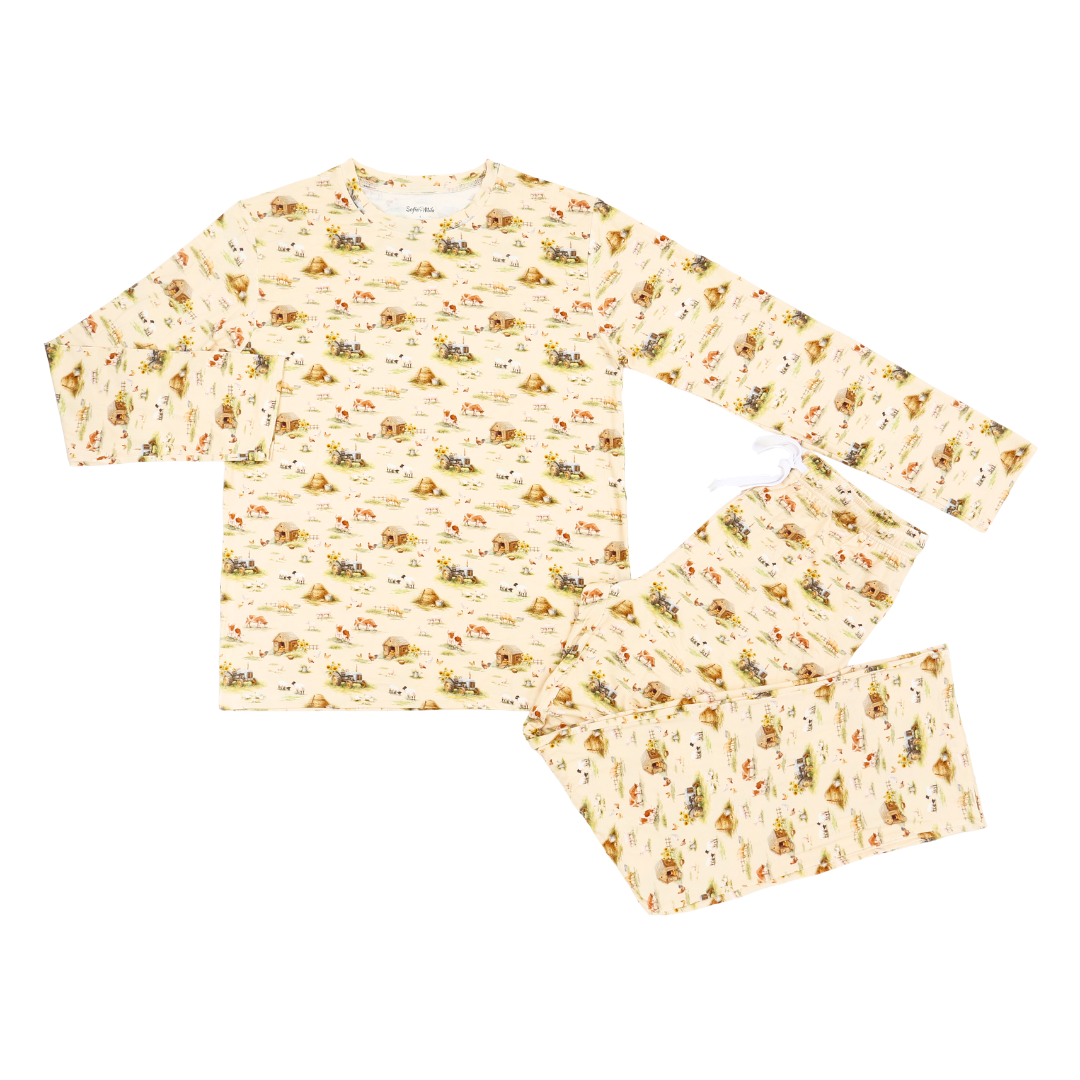 A two-piece long-sleeve pajama set featuring a cream-colored base with a repeating pattern of small sunflowers, bees, and butterflies, laid flat on a white background.