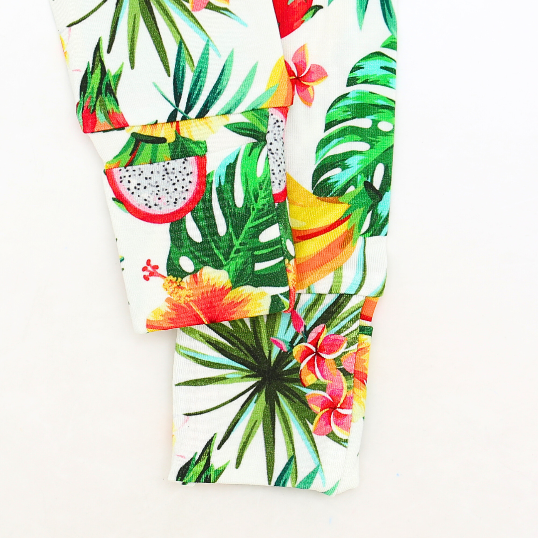 Tropical leaf and fruit patterned fabric on a white background