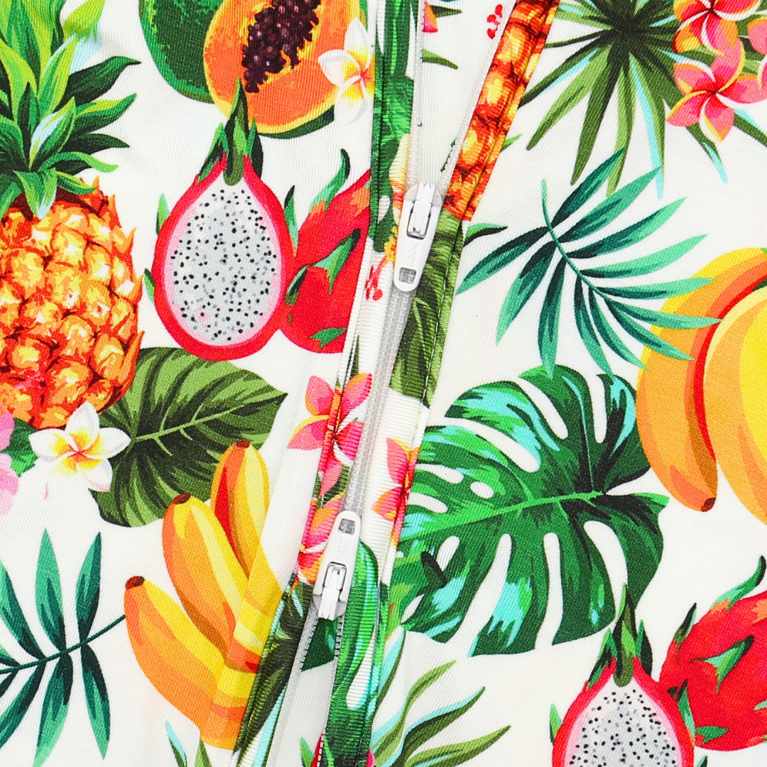 Tropical fruit and leaf pattern with a zipper in the center on a white background