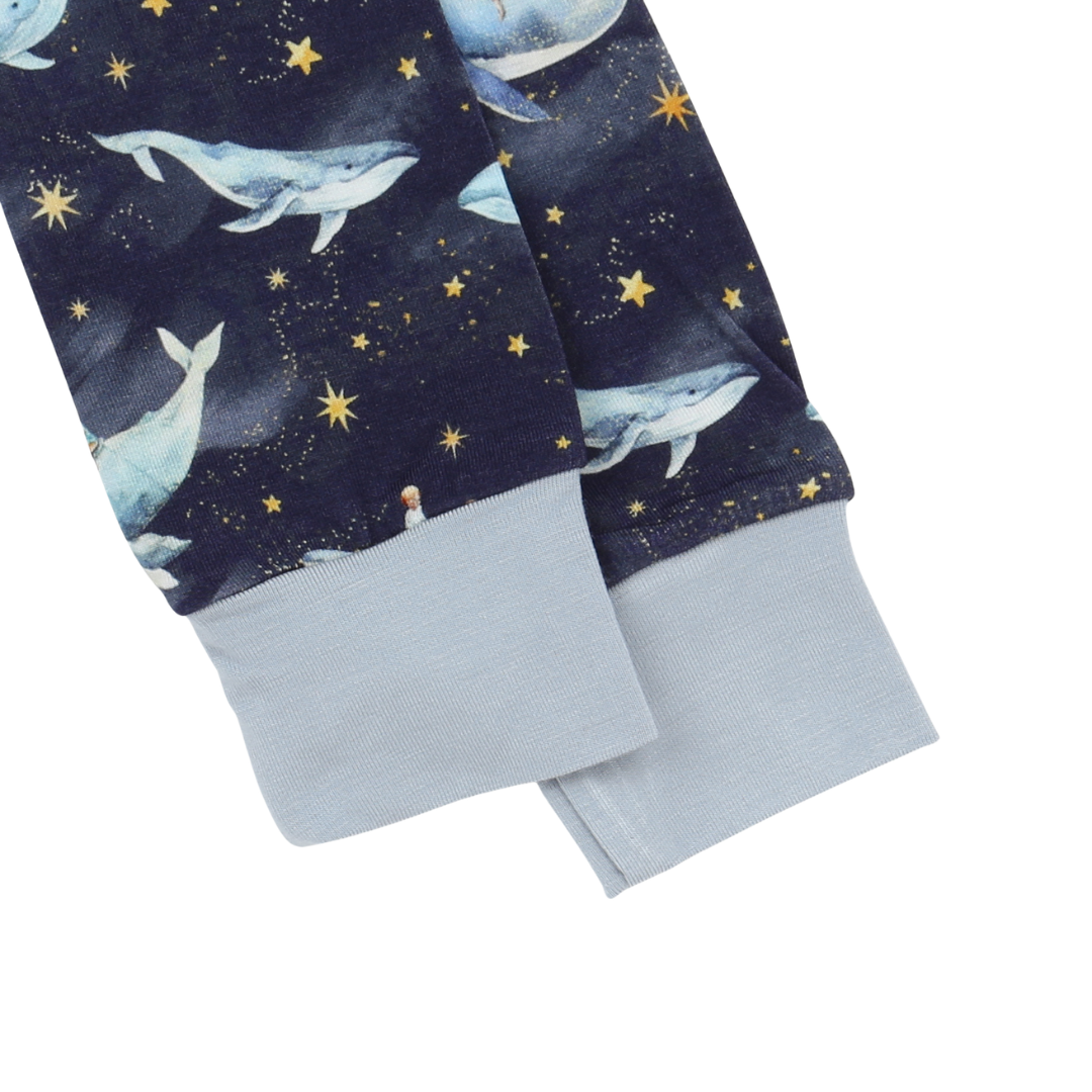 Children's pants with whale and star pattern on a dark blue background