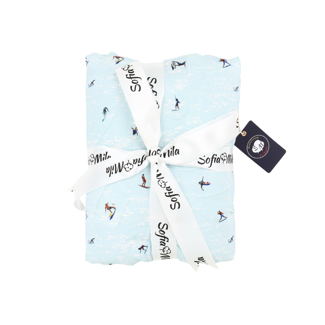 Folded baby blanket with text and graphics on a white background