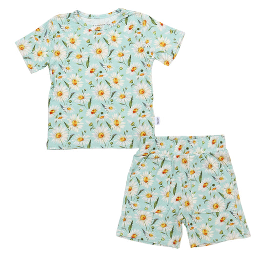Children's pajama set with floral pattern on a light blue background