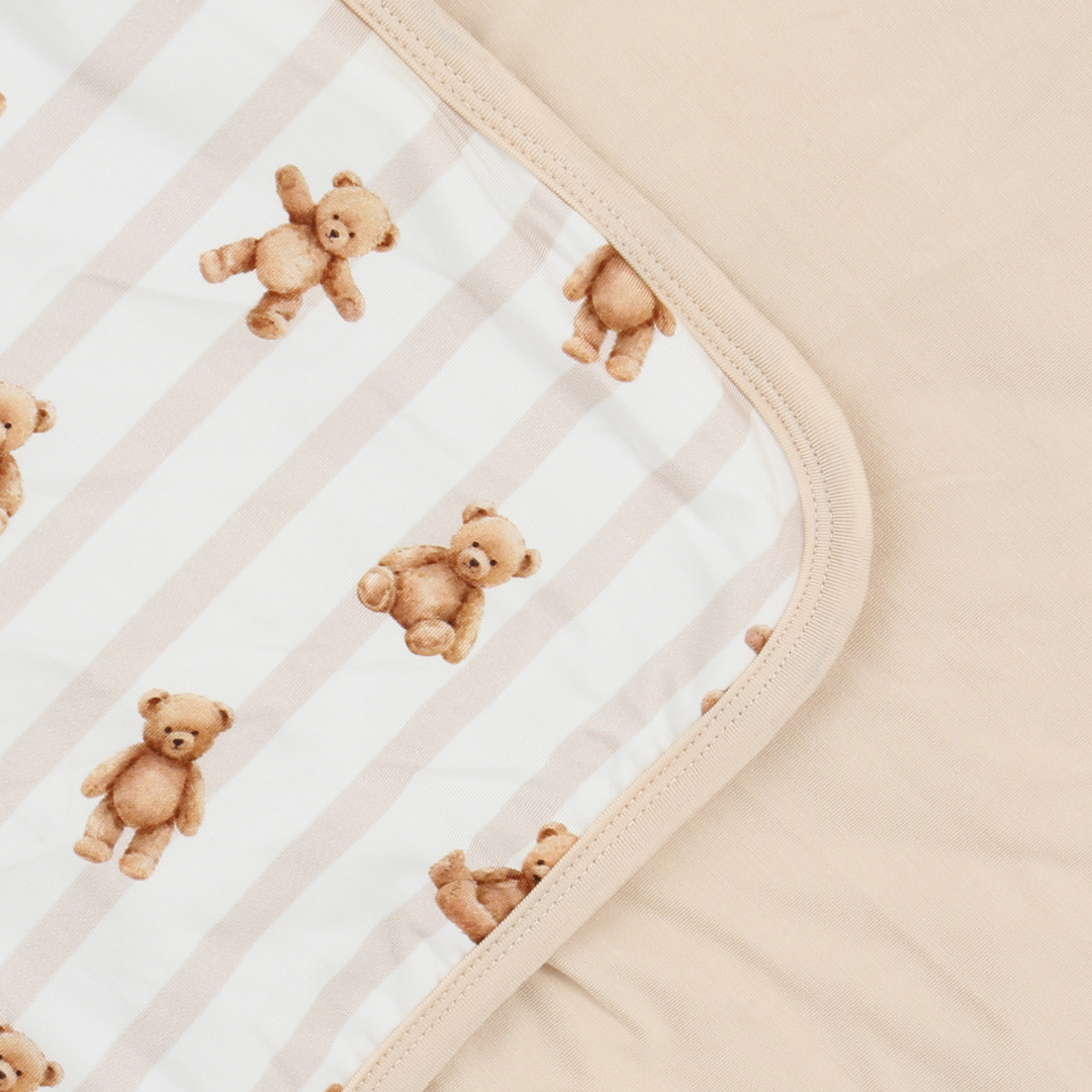 Pattern of small teddy bears on a textured fabric background