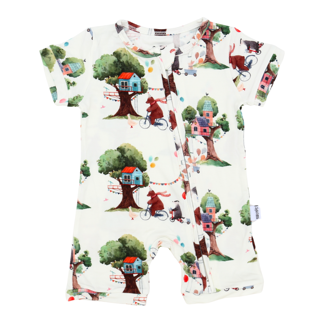 Baby romper with treehouse and bicycle pattern on a white background