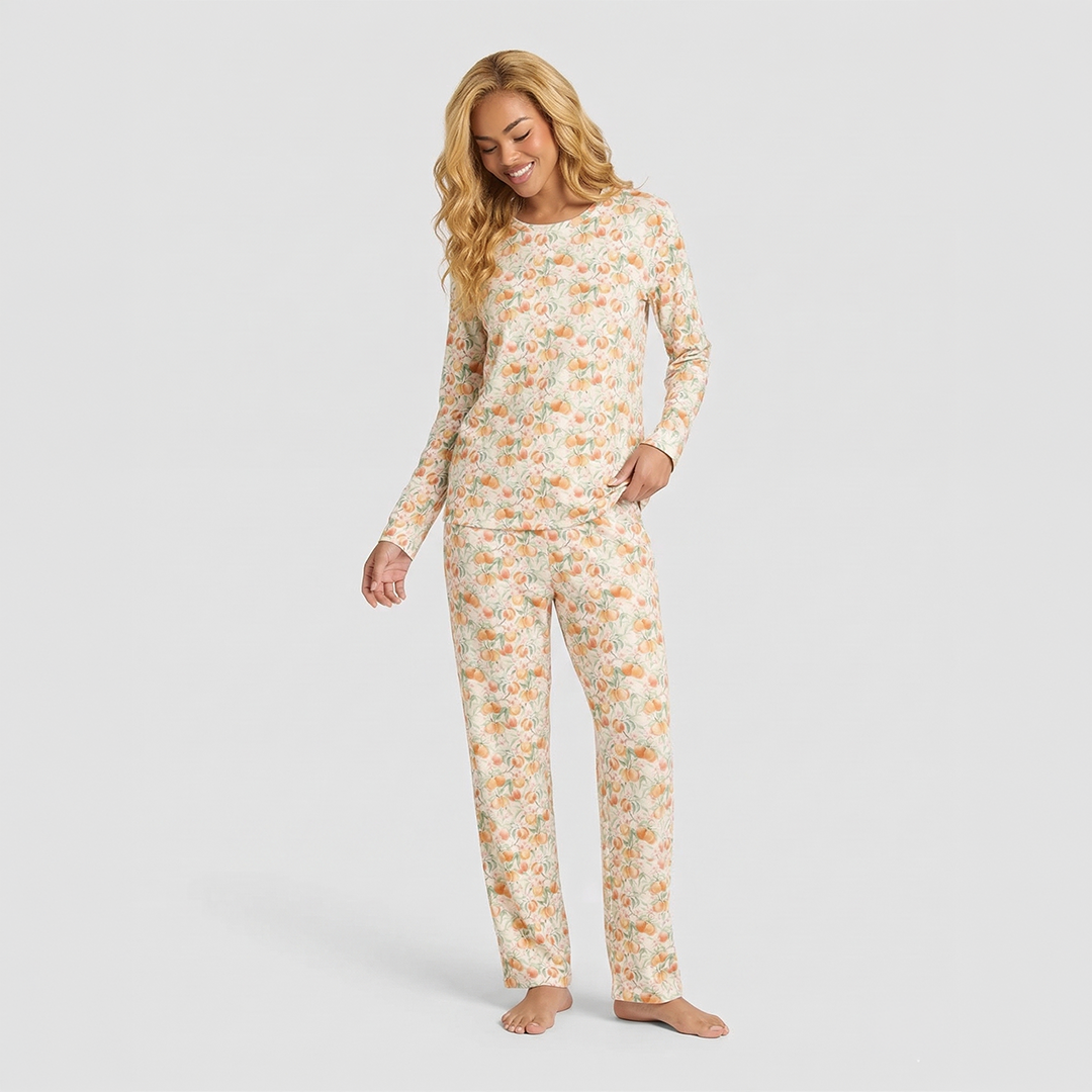 Woman wearing a floral pajama set on a plain background