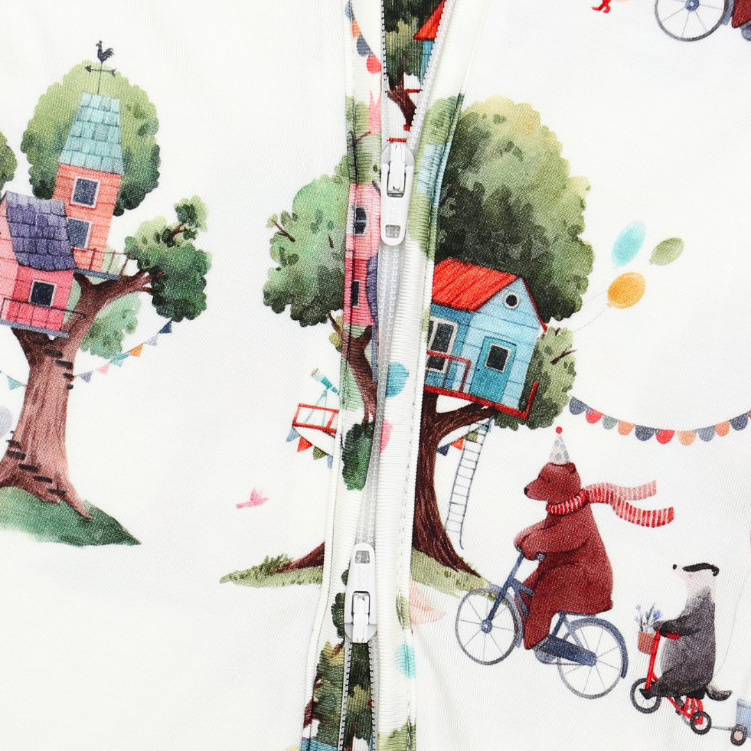 Zipper with a colorful illustration of a treehouse, houses, and characters on a white background